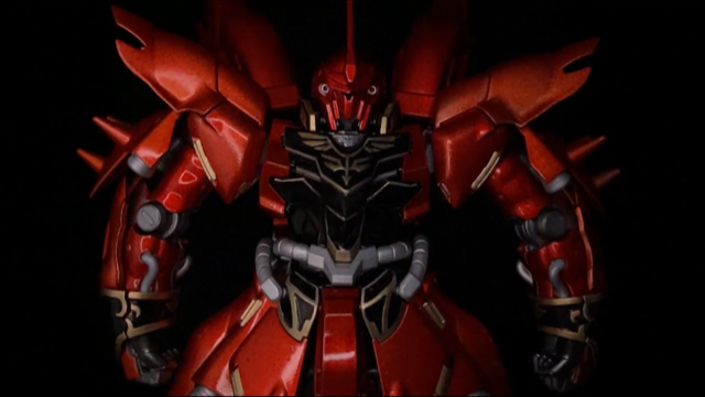 Image of a red painted gundam model kit under dramatic lighting